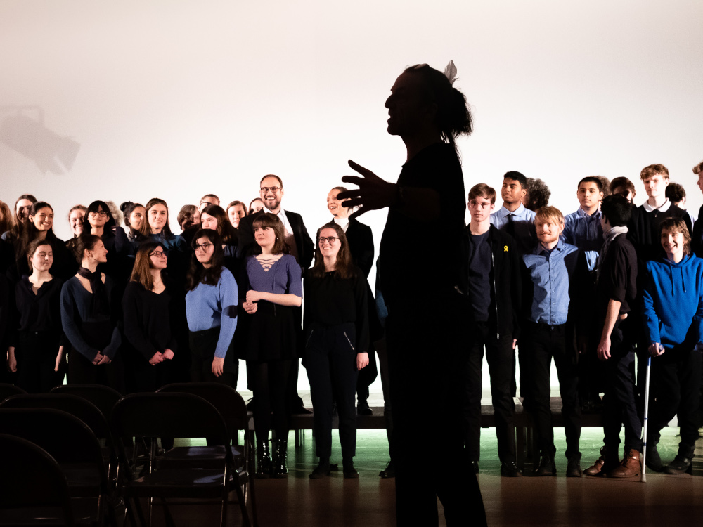 ein Solist als dunkle Gestalt vor dem Chor